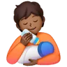 Person Feeding Baby: Medium-Dark Skin Tone Emoji 🧑🏾‍🍼 image - Samsung style